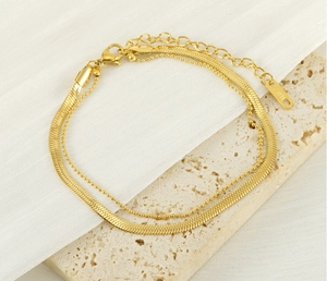 Detail of 18K gold plated double layer anklet with flat snake chain and beaded link