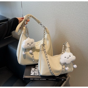 Detail of cream woven leather shoulder bags with silver chains and cloud charms