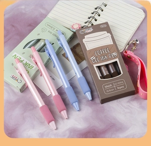 Close-up of 0.5mm black ink retractable gel pens with soft grips and coffee-themed boxes