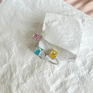 Detailed macro view of S925 silver rings with square pink blue and yellow gemstones