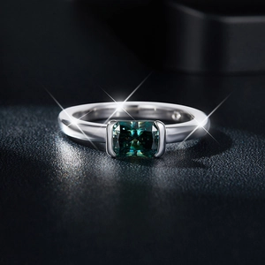 Macro shot of S925 silver ring featuring a radiant cut emerald green moissanite stone