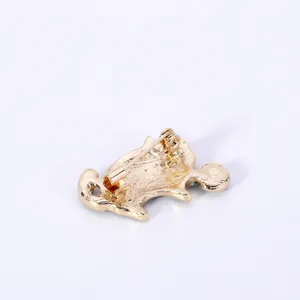 Detailed back view of a gold cat brooch showing the secure horizontal safety pin clasp