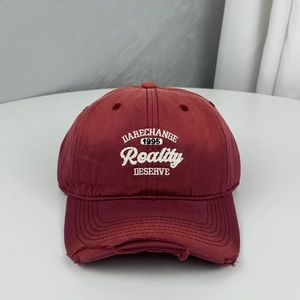 Maroon distressed baseball cap featuring white Reality letter embroidery and ripped brim