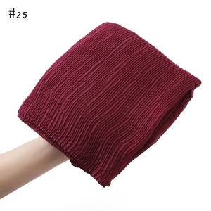 Detail of dark red pleated cotton linen scarf showing fine accordion fold texture