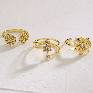 Set of three gold-plated flower and star open rings with shimmering pavé zircon stones