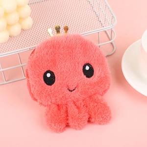 Close-up of pink plush octopus coin purse with golden crown and cute embroidery detail