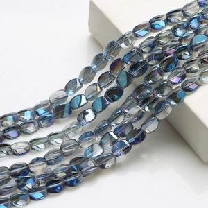 Macro shot of blue faceted crystal glass beads with iridescent gradient on white prop