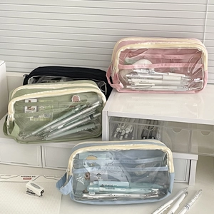 Macro detail of multi-layer mesh pencil cases in pastel pink, green, blue and black colors