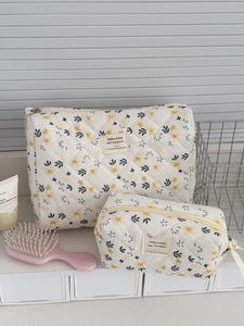 Almond yellow floral corduroy makeup bag set with quilted texture in a home setting
