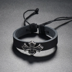 Detail of adjustable woven leather bracelet with vintage silver cross and rustic texture