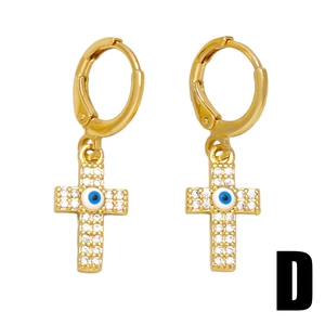 Golden huggie hoop earrings with crystal cross charms and blue evil eye detail
