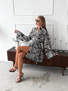 Chic black and white printed long sleeve mini wrap dress with waist tie and V-neckline