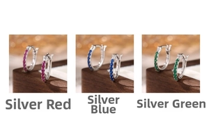 Close-up of 925 silver hoop earrings with inset red, blue, and green cubic zirconia crystals