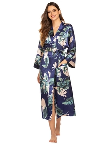 Close-up of tropical leaf print on satin bathrobe with belt and functional side pockets