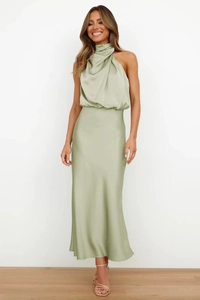 Detail of elegant bean green satin halter maxi dress showing premium silk texture and drape