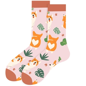 Detail of pink Corgi print crew socks featuring tropical leaves and contrasting red heels