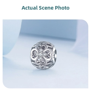 Macro shot of S925 sterling silver hollow clover charm with sparkling cubic zirconia