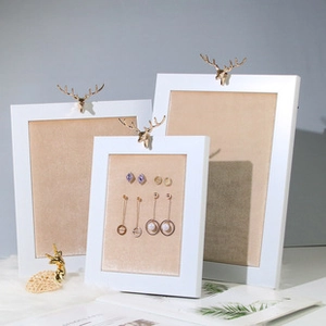 Three sizes of jewelry display frames with white frame and golden deer head decoration