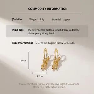 Detail showing dimensions of gold leaf tassel earrings with silver needles and measurements