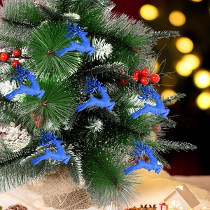 Blue glitter reindeer ornaments hanging on snowy Christmas tree branch with red berries