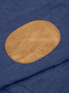 Detailed macro shot of navy blue corduroy fabric with tan oval elbow patches