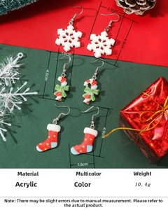 Detailed view of acrylic Christmas earrings with snowflake and candy cane design