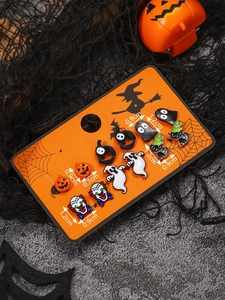 Detailed view of Halloween earring set with pumpkin, ghost and bat charms on a card