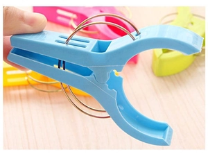 Detail of strong plastic clothespin with metal spring and anti-slip grip for laundry