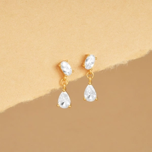 Macro view of gold S925 silver earrings with oval and water drop cubic zirconia stones