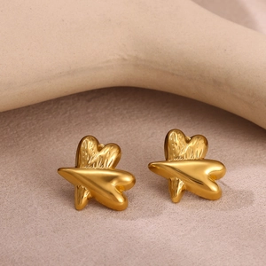 Macro shot of gold-plated stainless steel stud earrings with cross texture detail