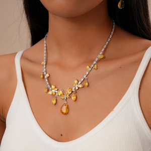 Detailed view of luxury butterfly necklace with yellow crystal drop pendant on neck