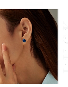 Detail shot of 8mm royal blue rose cut sapphire stud earring with 4-prong setting