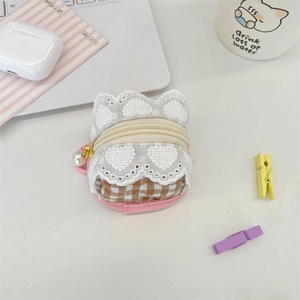 Close-up of cute floral lace and plaid headphone case with pearl pendant detail