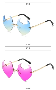 Detail of rimless heart sunglasses with devil horns in blue-green and pink gradients