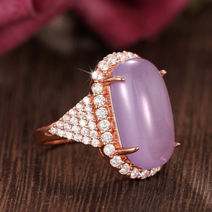 Macro shot of oval lavender faux moonstone ring in rose gold with pavé zircon setting