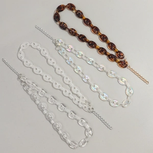 Four acrylic chunky link necklaces in leopard print and aurora colors with metal chain extension