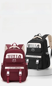 Detail view of large capacity school backpacks in burgundy and black with HELLO logo print