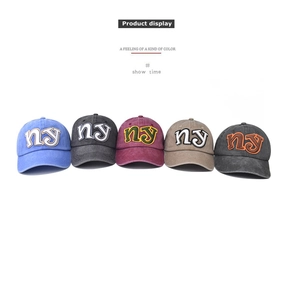 Detailed display of five colors of vintage washed cotton baseball caps with NY embroidery