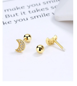 Detailed view of gold crescent moon earrings with white zircon inlays and screw backs