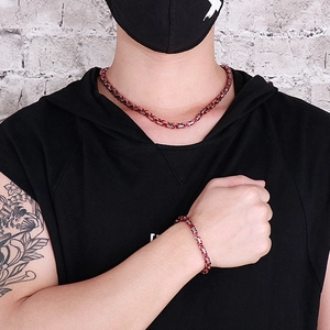 Detail of 5mm red and silver Byzantine chain necklace and bracelet set on male model