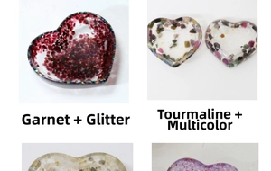 Macro view of heart-shaped resin trays with garnet and tourmaline crystal stones