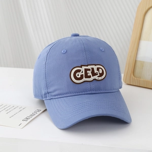Detailed view of blue cotton twill baseball cap with brown GELD embroidered patch