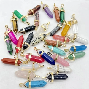 Assorted hexagonal crystal point pendants with golden caps displayed on white background