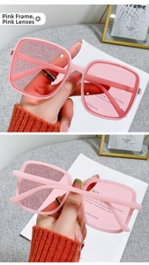 Close-up of pink square oversized sunglasses with transparent lenses and stylish frame
