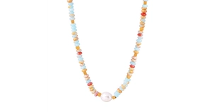 Close-up of bohemian colorful beaded necklace with a central large white pearl pendant