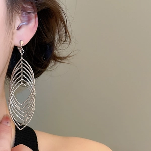 Macro shot of silver-colored layered hollow leaf-shaped clip-on earring for women
