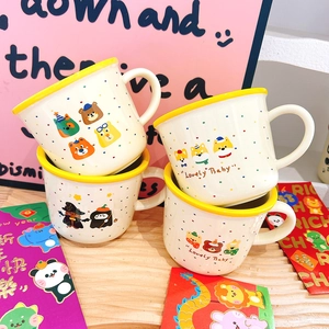 Cute ceramic mugs featuring colorful polka dots and cartoon animal illustrations with a yellow rim