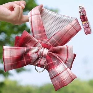 Detail of red and white plaid pet harness with large bow and breathable mesh lining