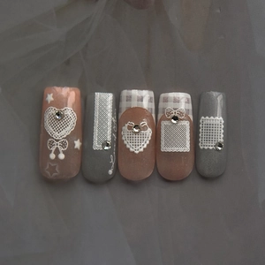 Lace heart and bow press-on nails with crystal rhinestones in pink and grey plaid design