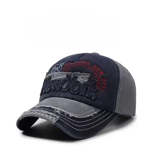 Detail of distressed navy blue baseball cap with New York embroidery and frayed brim texture